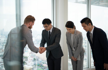 Japanese businessman people having a handshake with a colleague - Powered by Adobe