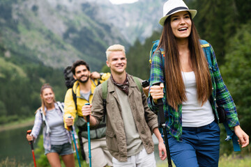 Adventure, travel, tourism, hike and people concept. Group of happy friends with backpack outdoors