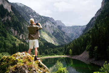 Traveler man relaxing with view mountains and lake landscape