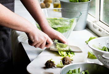 Cutting fresh vegetable with knife