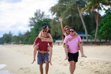 Group of friends having fun walking relaxing on the beach.Holiday and vacation concepts.