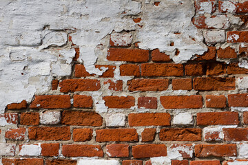Red and white brick background. Dilapidated brick wall. Grunge texture is red brick. White old plaster on the wall. Copy space.
