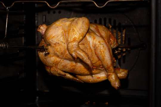 Cooking Chicken In The Oven Or In A Rotisserie Machine On A Grill Spit. Home Cooking.