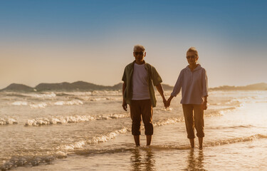 Happy family woman and man gray hair elderly older retire relax together while sunset seaside.