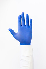Hand in blue latex Glove. Stop sign. White background. Copy space