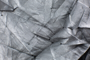 Gray Crumpled braided cotton net texture background. Close up. © Vadym