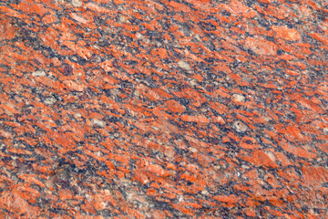 Natural mountain red granite background with impregnation of minerals