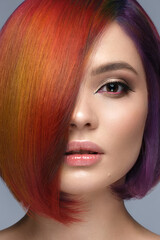 Beautiful woman with multi-colored hair and creative make up and hairstyle. Beauty face.