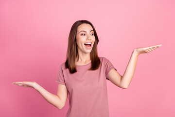 Photo of young girl happy positive smile hold hands weighing measure scales advert isolated over pink color background