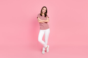 Full length body size view of attractive cheerful girl folded arms isolated over pink pastel color background