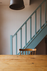 scandinavian chair in front of blue stairs