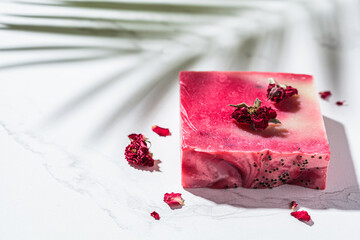 Rose soap on white marble background. Eco cosmetics, natural body care.
