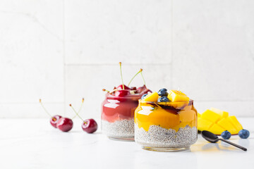 Chia pudding with fruit and berry smoothies in jar. Healthy food concept, vegan breakfast.