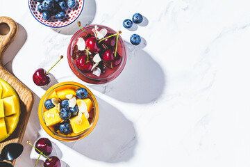 Mango and berry smoothie in jars, top view. Healthy food concept, vegan breakfast.