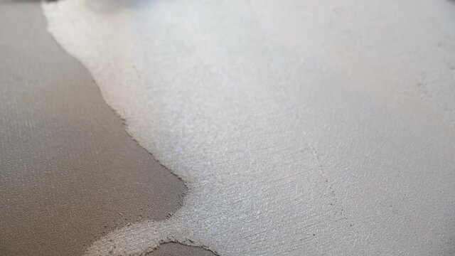 grey plaster is generously applied to a special mesh prepared surface. stains and coating texture