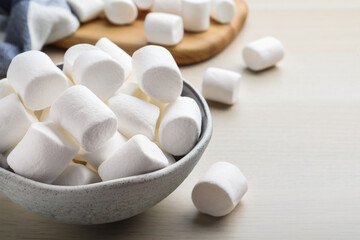 Fototapeta na wymiar Delicious puffy marshmallows on wooden table, closeup