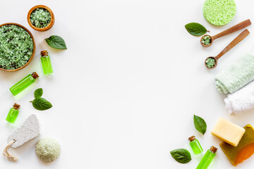 Frame of tea tree cosmetics with essential oil and green leaves
