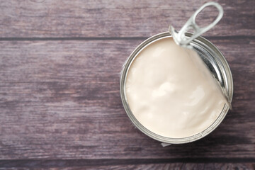 Fototapeta na wymiar top view of milk cream in a container on wooden background,