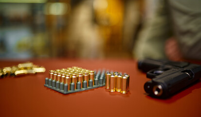 Pistol bullets in stand on counter in gun store