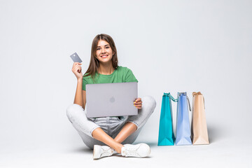 Smiling young woman shopping with credit card