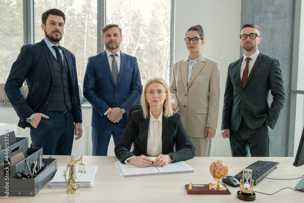 Aufkleber Portrait of successful business team with their leader looking at camera while working in team at office