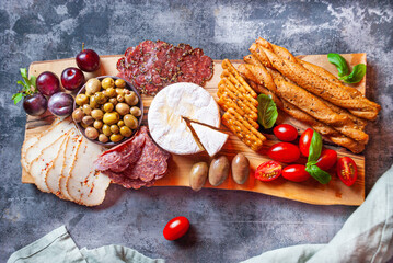 Charcuterie board with camembert cheese