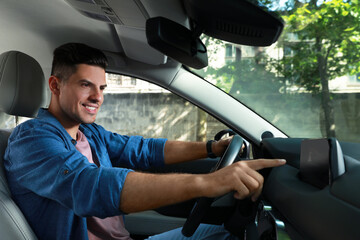 Man using navigation system while driving car