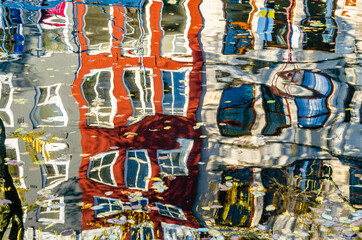 Colorful reflection of the buildings along the canal in Amsterdam in the autumn