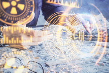 Double exposure of man's hands holding and using a digital device and tech theme hologram drawing. Technology concept.