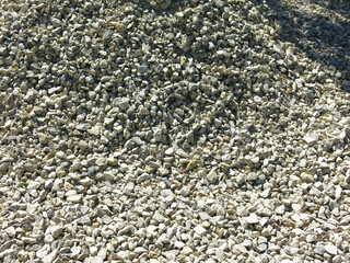 pile of small rubble, gravel lies on the road, an industrial background