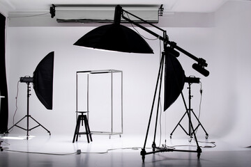 Photo studio interior with professional equipment, cyclorama and strobe lights