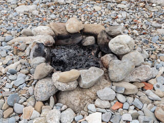 bonfire extinguished on the pebble beach