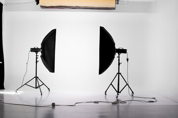 Photo studio interior with professional equipment, cyclorama and stripbox light modifiers