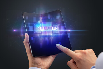 Obraz premium Businessman holding a foldable smartphone
