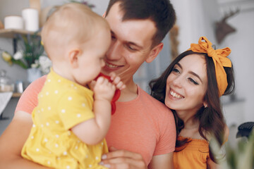 Mother and father feed their daughter a paper