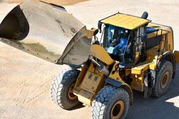 heavy construction machine in open-cast mining - wheel loader transports gravel in a gravel plant