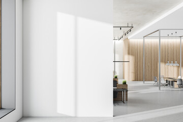 Blank sunny light wall with shadow in modern office with wooden wall, tables and concrete floor. 3D rendering, mockup