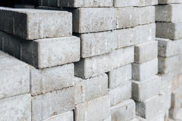 Gray silicate bricks are stacked. Industrial background. Concept of construction.