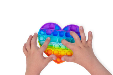 Child is played with an anti-stress toy pop it. Popular children's toy pop it for fine motor skills isolated on white background.