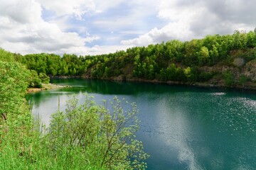 View of the old flooded quarry. Bathing. The village of Vykleky. Central Moravia. Europe. 
