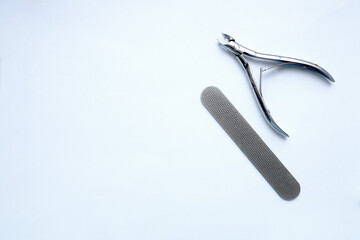 Beauty and fashion concept - manicure tools. Two tweezers on a white background. copyspace layout