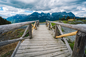 Small bridge at Astberg lake with wilderkaiser mountains in background. Ellmau, Austria