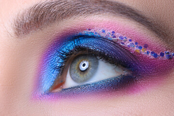 Bright female makeup from multi-colored shadows macro