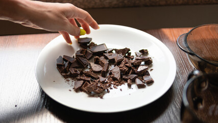 A broken bar of milk chocolate on the plate