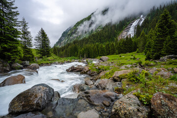 Mountain blue water river and trees landscape natural environment. Hiking in the alps. Grawa Waterfall in Stubai Valley, Tyrol, Austria