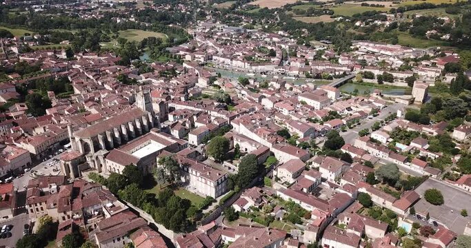 Aerial view of Condom cityscape on banks of Baise river overlooking Catholic cathedral, France