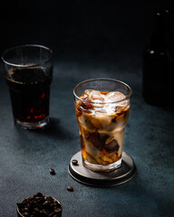 Ice coffee in a tall glass with cream poured over. almond milk latte. Cold summer drink. Cold brew in glass. vegetarian coffee in glass. Vietnamese Iced Coffee. vegan latte