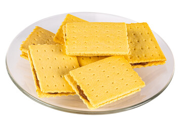 High angle view pile of homemade crispy pineapple cheese shake biscuit in transparent glass dish on white background.