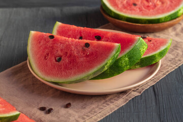 On the dessert plate there are three slices of juicy and ripe watermelon