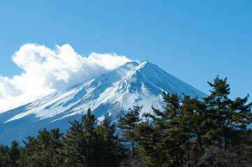 Mount Fuji in winter covered with snow with beautiful blue sky and white cloud.